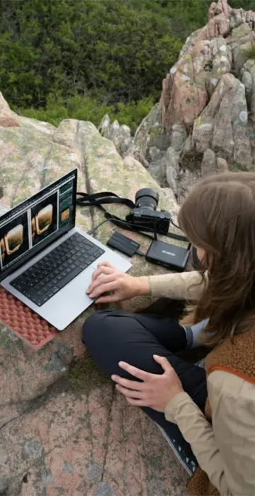 The girl works at outdoor at the laptop